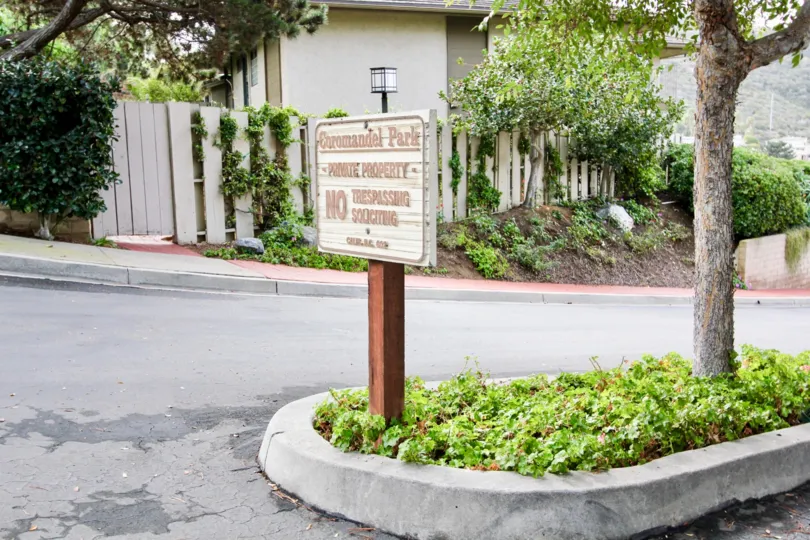Community sign on planter near tree at Coromandel Park in La Jolla California
