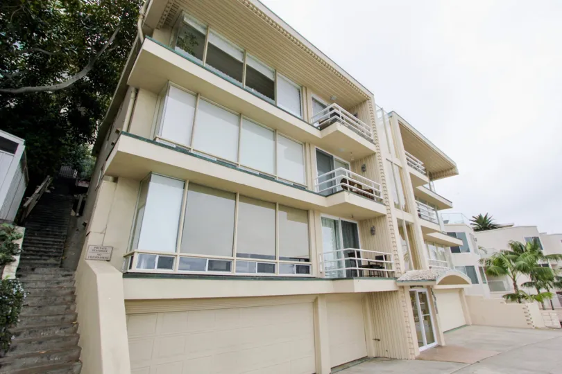 The Stair in the left side of the apartments and balcony with dinning table with two chairs