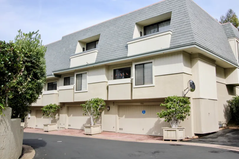 Three story residence with gray roof tops at Del Charro Woods in La Jolla California