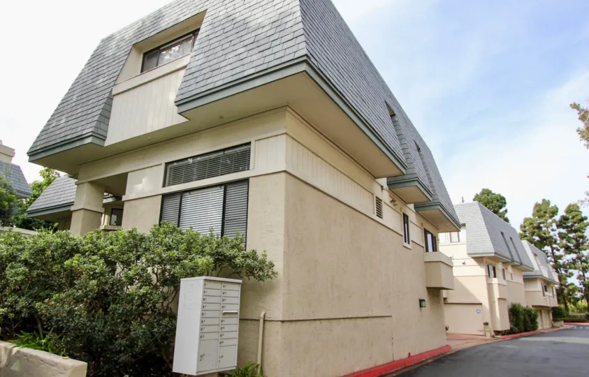 Brown building with gray rooftop at Del Charro Woods in La Jolla CA