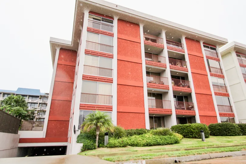 Five story pink condominiums with underground parking at Devonshire in La Jolla CA