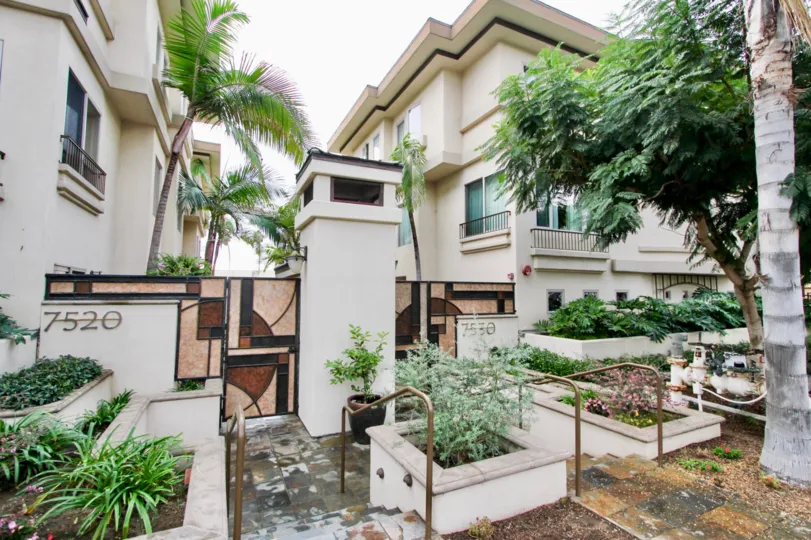 Elaborate walkway with marble flooring and plants inside Draper Villas in La Jolla CA