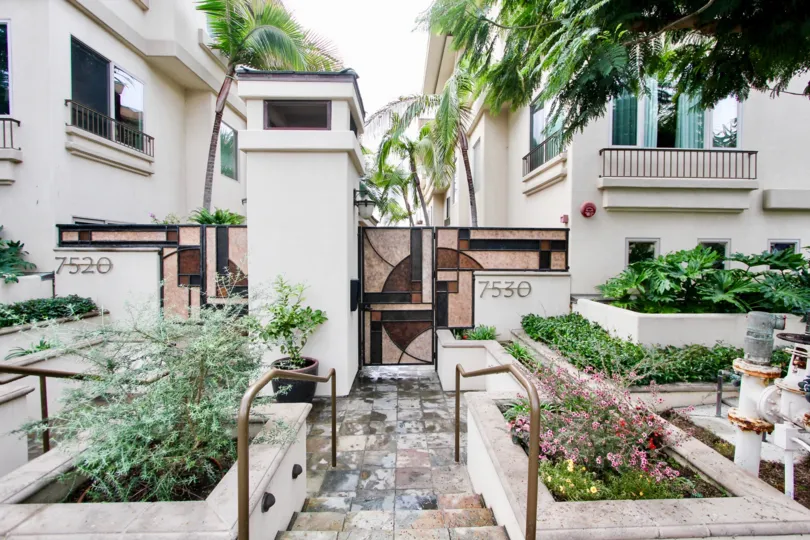 Marble walkway and garden inside Draper Villas in La Jolla California