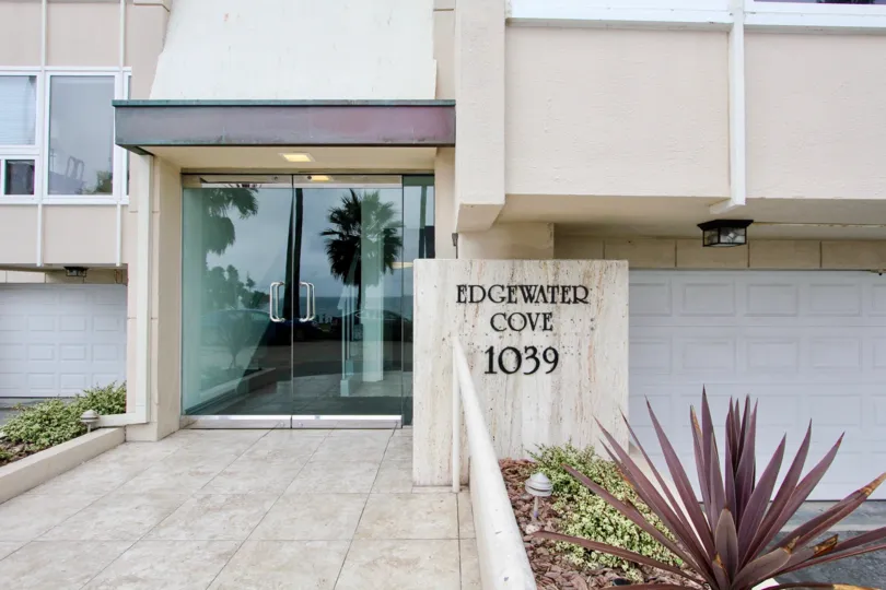 Tiled floor with glass door of Edgewater Cove with garden lights.