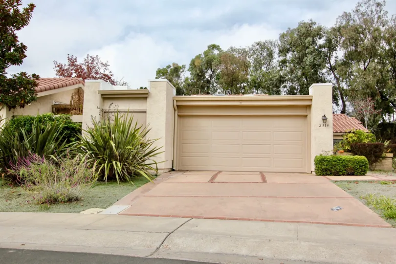 Brown garage door with pink driveway at El Dorado in La Jolla CA