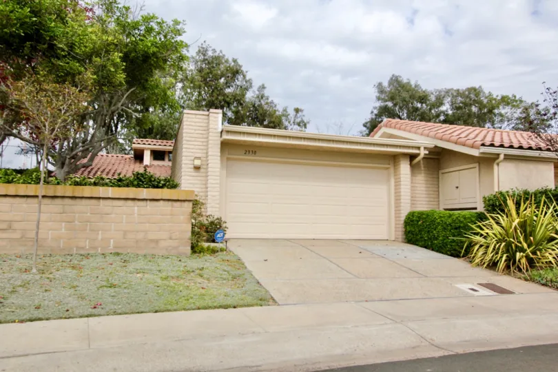 Single story home with brown garage at El Dorado in La Jolla California