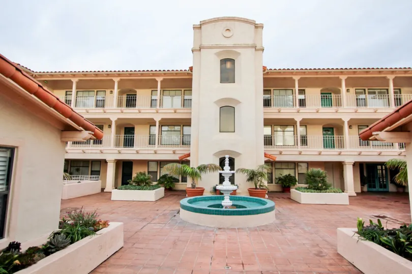 Three story housing units with a water fountain at La Flor De La Jolla in La Jolla CA