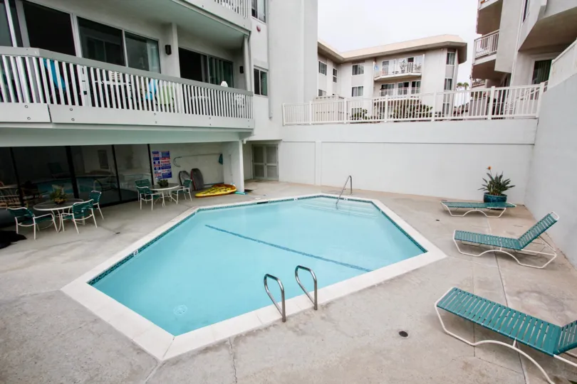 Coffin shaped swimming pool with lawn chairs at La Jolla Chelsea in La Jolla California