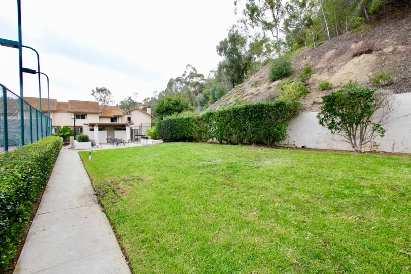 La Jolla Hideaway's lush green yard at the base of a hillside in La Jolla CA