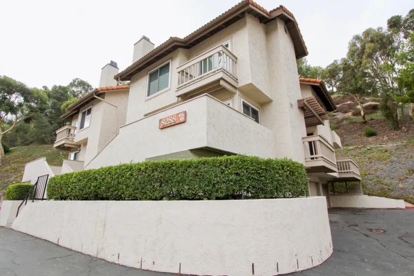 Steep driveway near tree story housing and planters inside La Jolla Hideaway in La Jolla CA