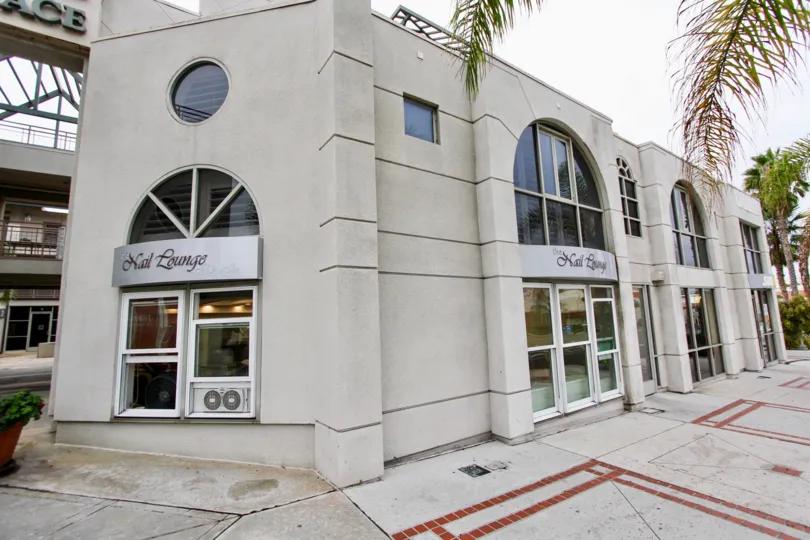 Two story building with silver and black sign at La Jolla Market Place in La Jolla CA