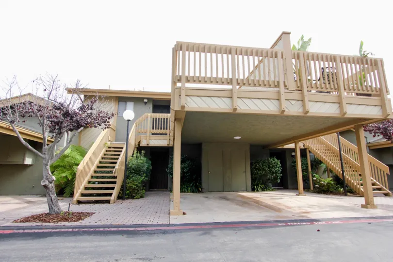 Two story residential units with wooden stairways inside La Jolla Park Villas in La Jolla CA