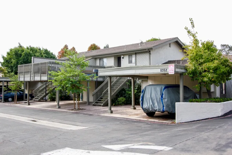 This is my house with trees around and my car is parked near my house