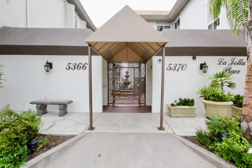 An entrance to the community La Jolla Place with a triangular roof.