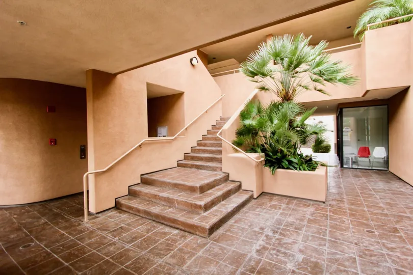 Pink & tile stairway next to palm trees inside La Jolla Promenade in La Jolla CA