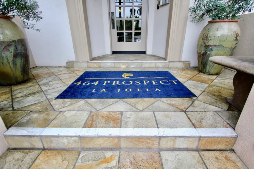 IN entrance, Mat has " 464 prospect la jolla" lines in the La JOlla Prospect Condos