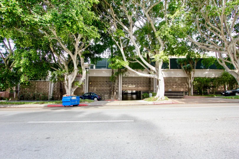 The La Jolla Racquet Club with wide campus filled with tall trees around