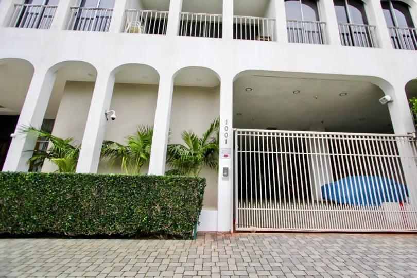 Several buildings in La Jolla Seville with palm trees and archways