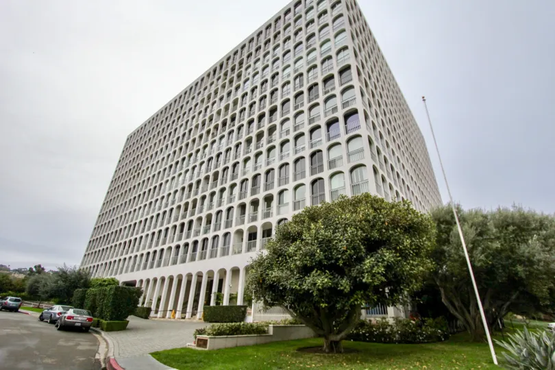 Tall housing structure with many trees at La Jolla Seville in La Jolla CA