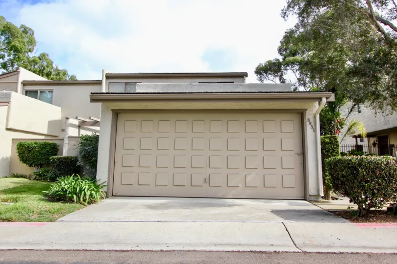 THE HOUSE IN THE LA JOLLA SHORES HEIGHTS WITH THE GRASSLAND, PLANTS, TREES, SHUTTER
