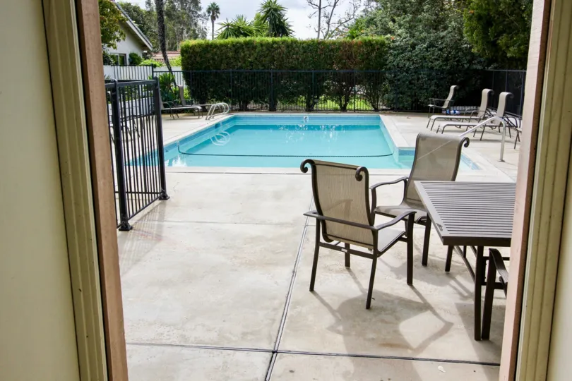 Swimming pool and dining table are at the La Jolla Woods community placed in the state CA