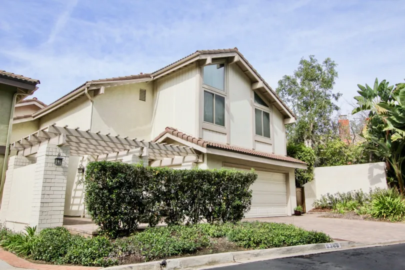 Two story housing with plants in front inside La Jolla Woods in La Jolla CA