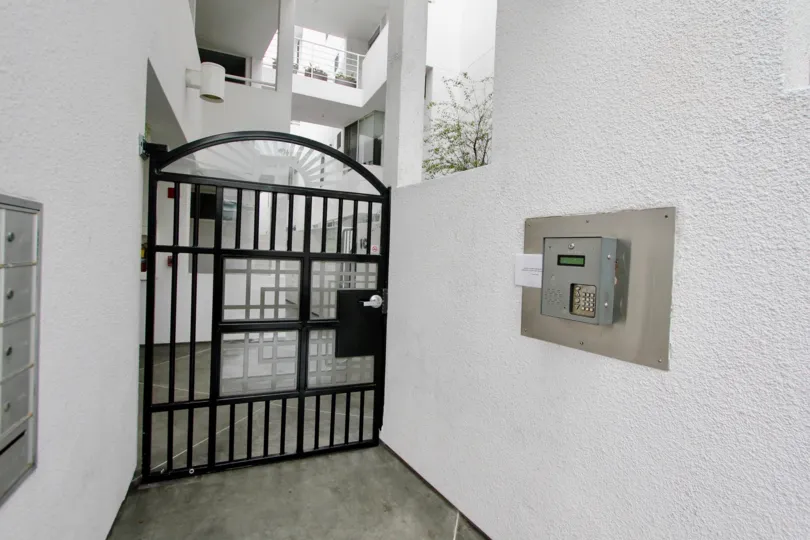 Black iron gate near intercom inside Lighthause in La Jolla California