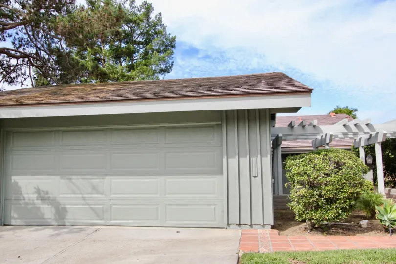 This is the regular front yard driveway of an American citizen's house, with automatic garage door and lawn