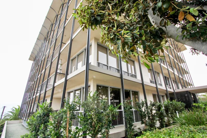 Condominium high rise surrounded by trees inside Park Prospect in La Jolla CA