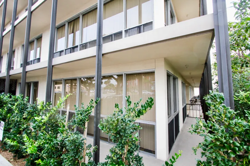 A building that is multiple floors with large glass windows in Park Prospect community.