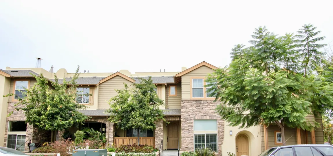 Two story units with a stone wall at the Paseo La Jolla Community in La Jolla CA
