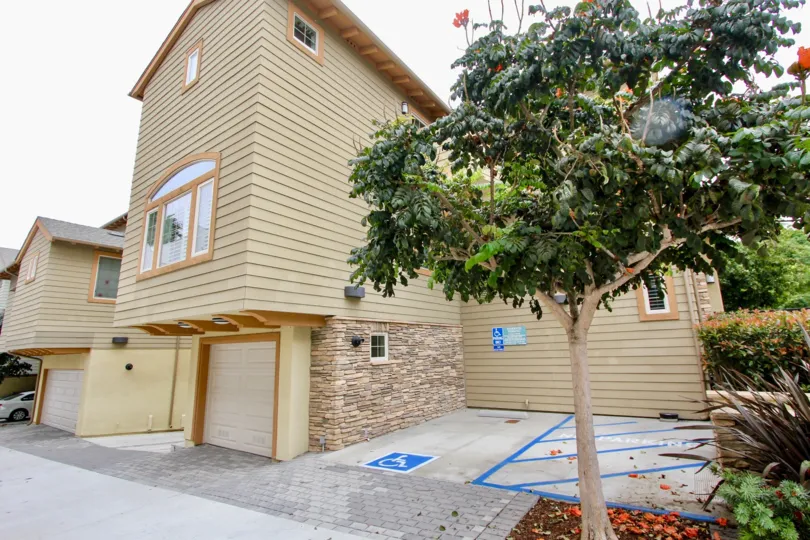 Blue handicap parking space next to residential unit at Paseo La Jolla in La Jolla CA