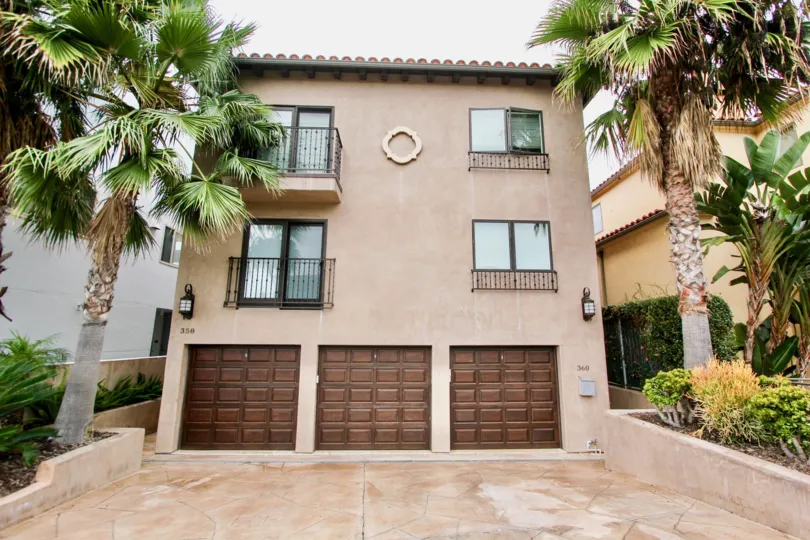 Three story pink condos with attached garages inside Prospect Seaview Villas in La Jolla CA