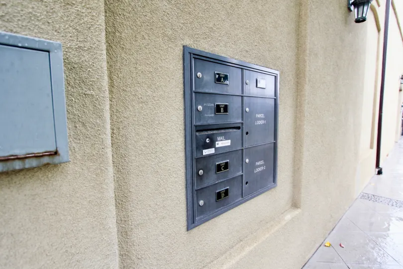 Mail boxes on a brown wall inside Prospect Village in La Jolla CA