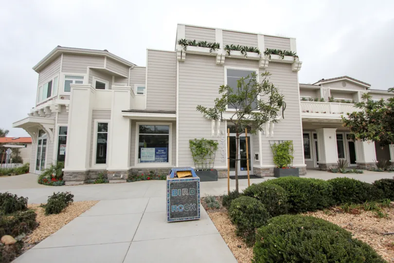 The place In Rosemont Condos has dustbin in the path way and trees and plants