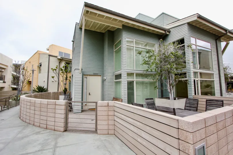 Two story housing with brown security wall inside Seahaus in La Jolla CA