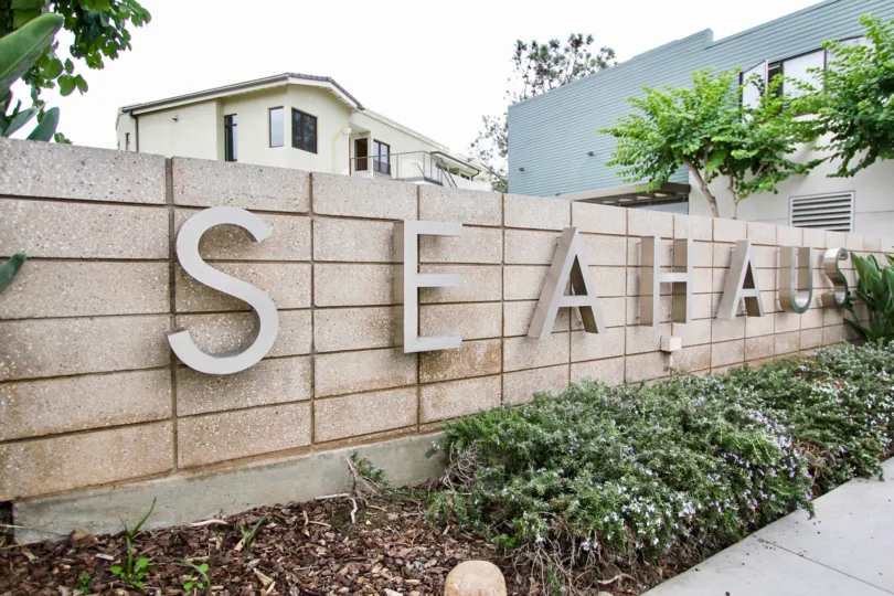 Tiled wall with side view buildings with bushes of Seahaus.
