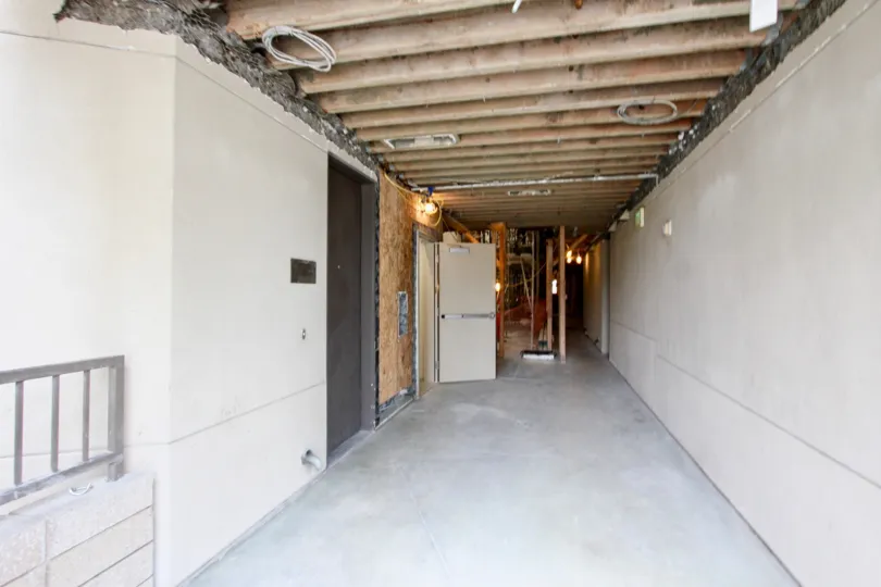 Dilapidated hallway with exposed wires inside Seahaus in La Jolla CA