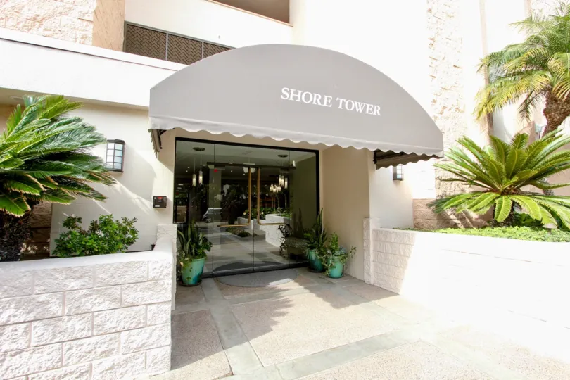 Front entry to Shore Tower in La Jolta, CA on a pretty day.
