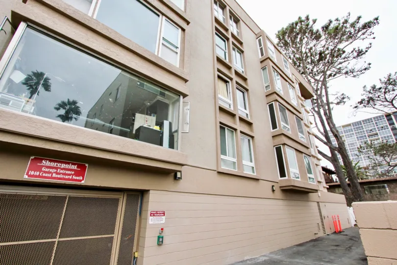 Garage entrance to an office building with many windows in Shorepoint community in La Jolla, CA.