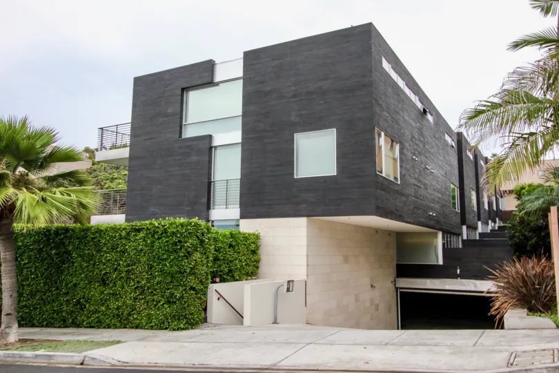 A sunny day in the area of Six by Sebastian Mariscal house, garage