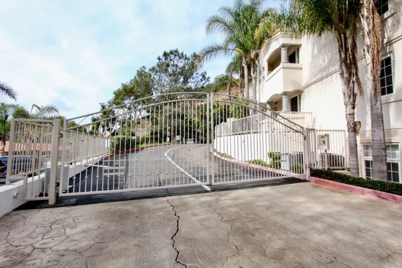 Large white gate at the entrance of St Tropez in La Jolla CA