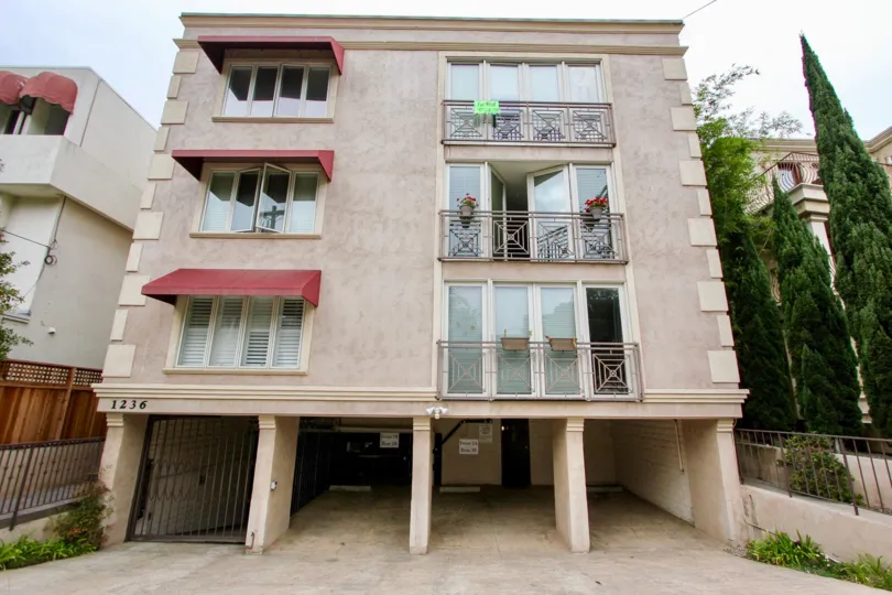 Front view of the apartment has 3 balcony with flower pot and glass windows