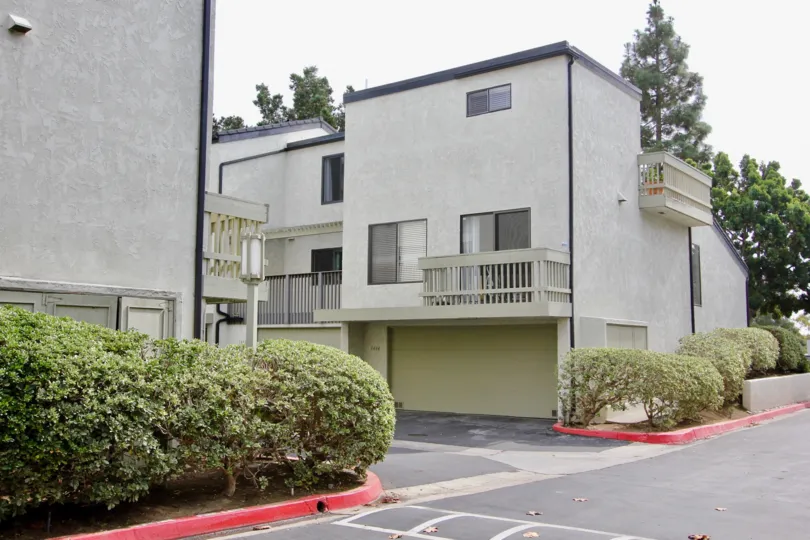 Odd shaped gray condominiums with garages in The Woodlands at La Jolla CA