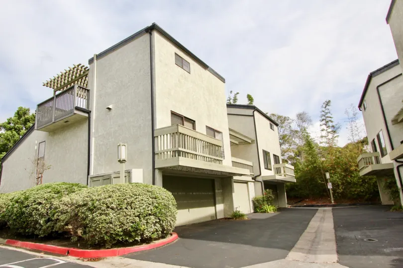 Three story building with large garages inside The Woodlands in La Jolla CA