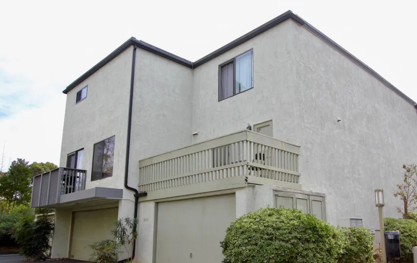 In the Woodlands, A house has two balgancy and glass windows with lamps