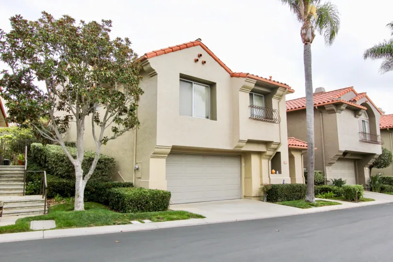 Two story home with gray garage inside Ventana community in La Jolla CA