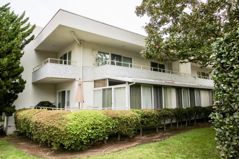 Two story residential units with hedges & trees in Villa Del Lido in La Jolla CA