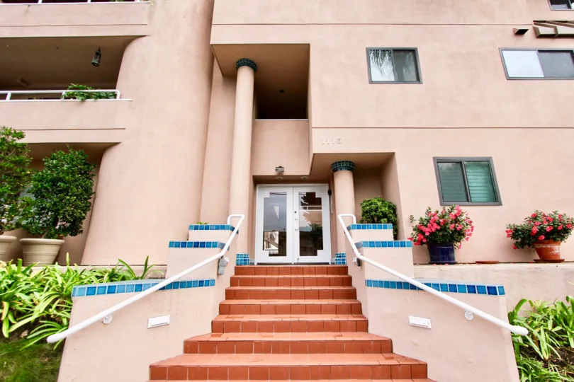 Pink stairway leading up to a pink high rise in Villa Italian in La Jolla CA