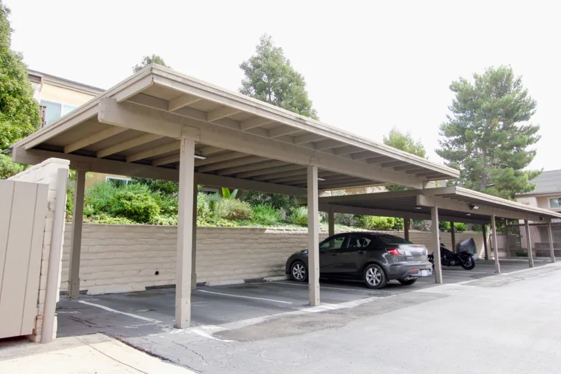 Car parking in front of villas and trees around in Villa La Jolla of La Jolla